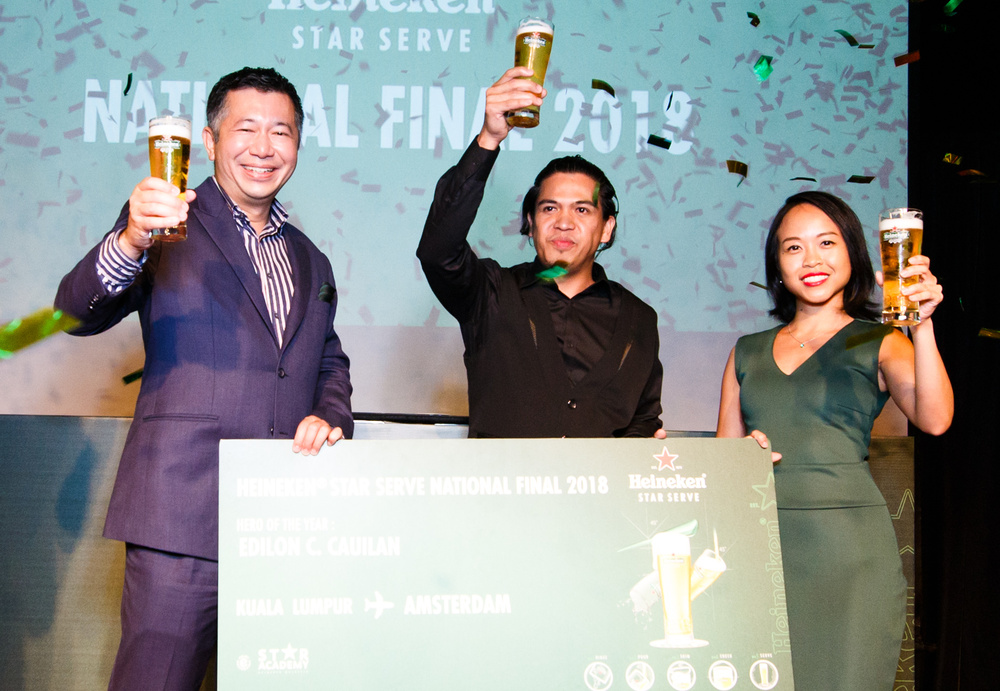 Sales director of Heineken Malaysia Berhad Andrew Woon (left) and senior brand manager Carmen Chong (right) with 2018's winner Edilon C. Cauilan. u00e2u20acu201d Pictures courtesy of Heineken Malaysia