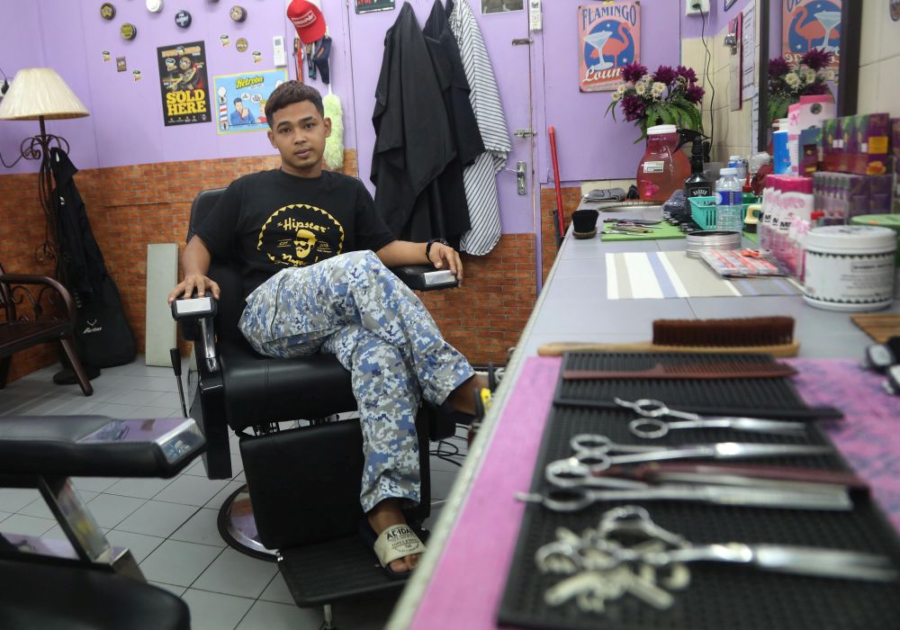 Hairdresser Badrul Mohd Yunos was planning to print flyers to let people know about his business when he heard about the HSR postponement. — TODAY pic