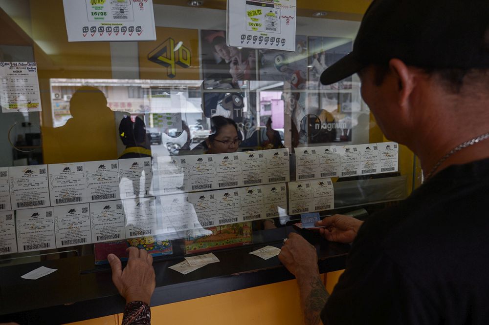 A man buys tickets at a Magnum 4D outlet in Kuching.