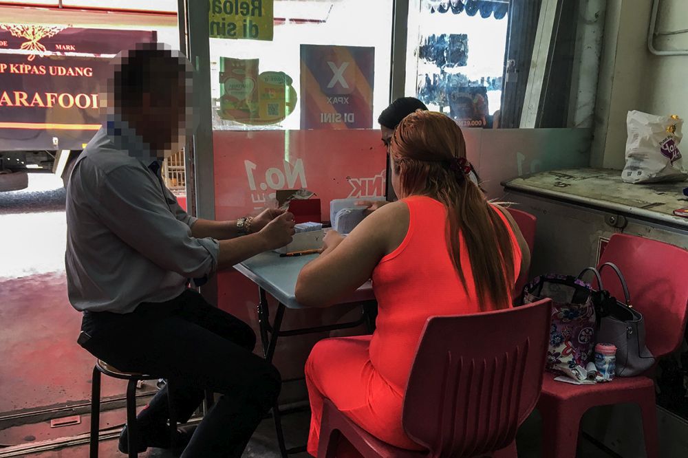 An illegal gaming counter out in the open at the entrance of a grocery shop in Kuching August 28, 2018. u00e2u20acu201d Picture by Mukhriz Hazim