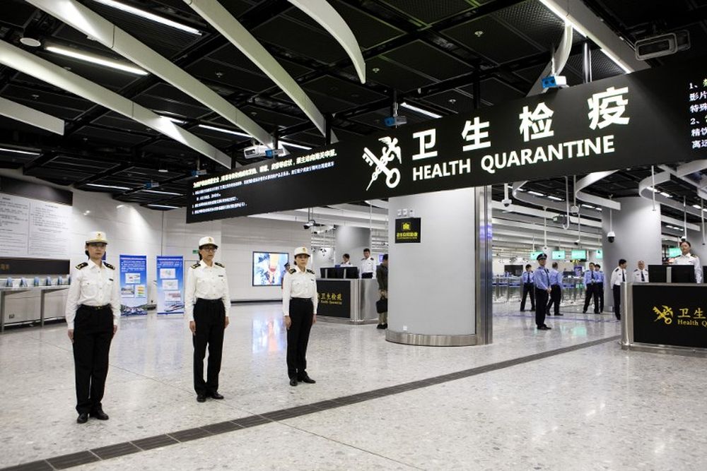 Officers stand under a sign reading ‘Health Quarantine’ at the West Kowloon Station in Hong Kong on September 22, 2018. The new rail link between Hong Kong and southern China will see joint immigration checkpoints in the heart of the city. — AFP pic