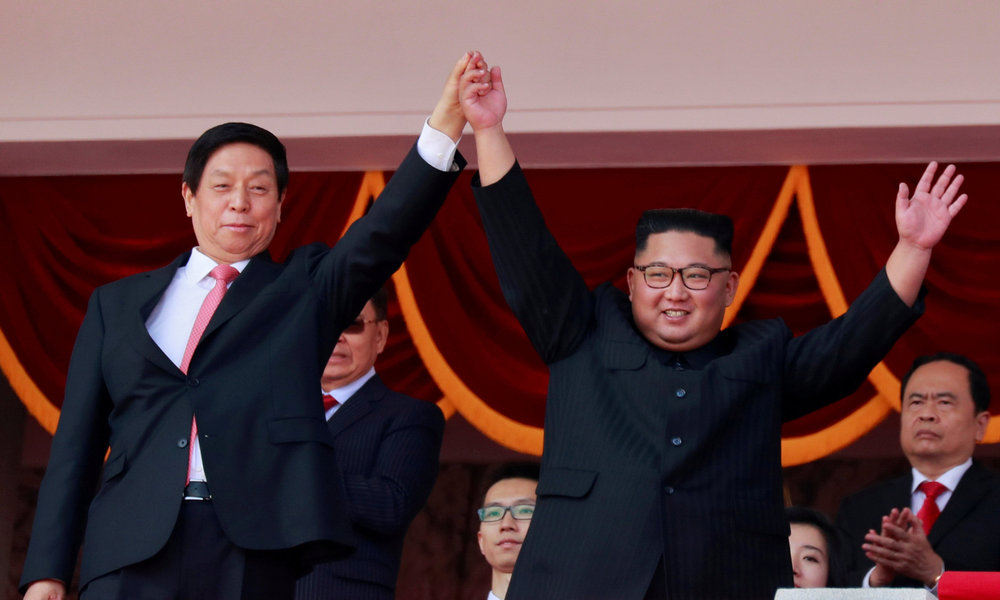 North Korean leader Kim Jong-un and China's Li Zhanshu, chairman of the Standing Committee of the National People's Congress (NPC), wave at a military parade in Pyongyang September 9, 2018. u00e2u20acu201d AFP pic
