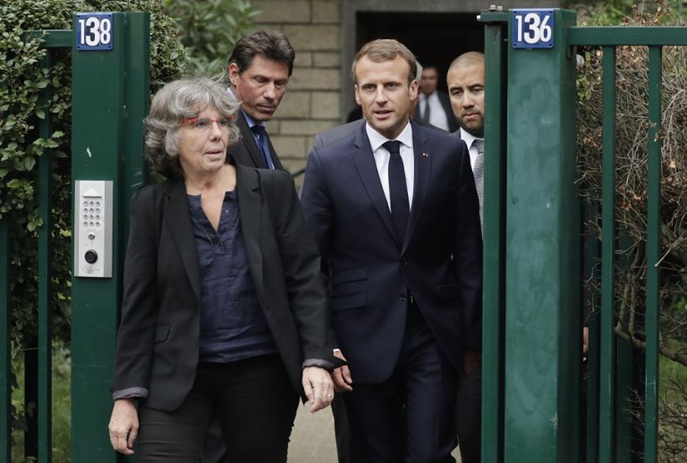 French President Emmanuel Macron (centre) walks next to Michele Audin, daughter of late Maurice Audin, as he leaves the home of Josette Audin, widow of Audin, on September 13, 2018 in Bagnolet. u00e2u20acu201d AFP pic
