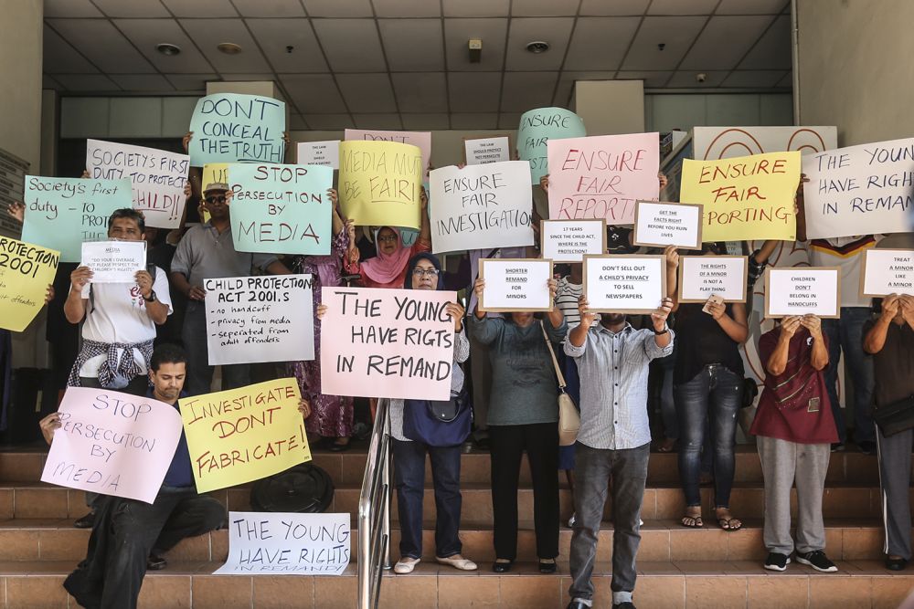 Demonstrators hold up placards demanding justice for the two stepsons of Nazrin Hassan, who are under a seven-day remand, at the lobby of the Petaling Jaya Majistrate's Court September 10, 2018. u00e2u20acu201d Picture by Azneal Ishak