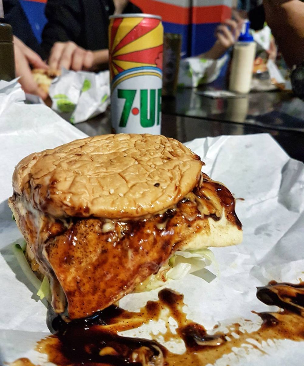 You can enjoy your burger with add-ons like cheese and fried eggs. ― Picture via Instagram/LUQMAN HAKIM