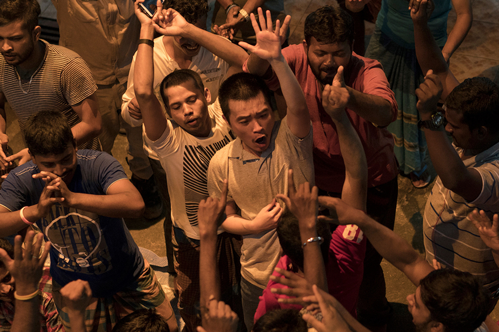 This undated handout photo released by Akanga Film Asia on September 26, 2018 shows Singaporean actor Liu Xiaoyi (centre) acting during filming of a scene for the movie u00e2u20acu02dcA Land Imaginedu00e2u20acu2122 in Singapore. u00e2u20acu201d AFP pic