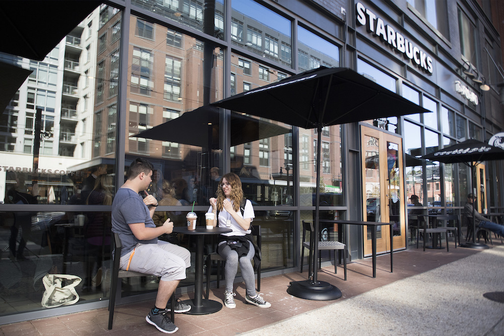 People sit outside the first US Starbucks cafe staffed by employees who are partially or fully deaf and capable of communicating in American Sign Language in Washington October 23, 2018. u00e2u20acu201d AFP pic