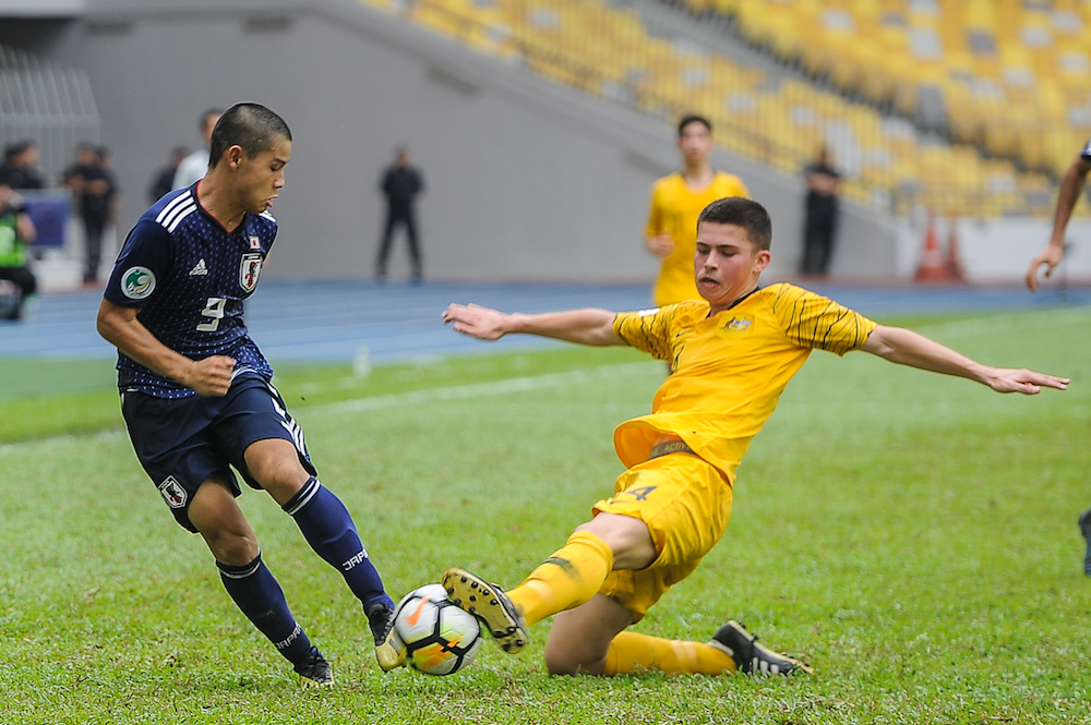Japanu00e2u20acu2122s Keita Nakano tries to get past Australiau00e2u20acu2122s Alexandar Popovic during the AFC U-16 Championship Malaysia 2018 semi-final match at the National Stadium Bukit Jalil, October 4, 2018. u00e2u20acu201d Picture by Shafwan Zaidon