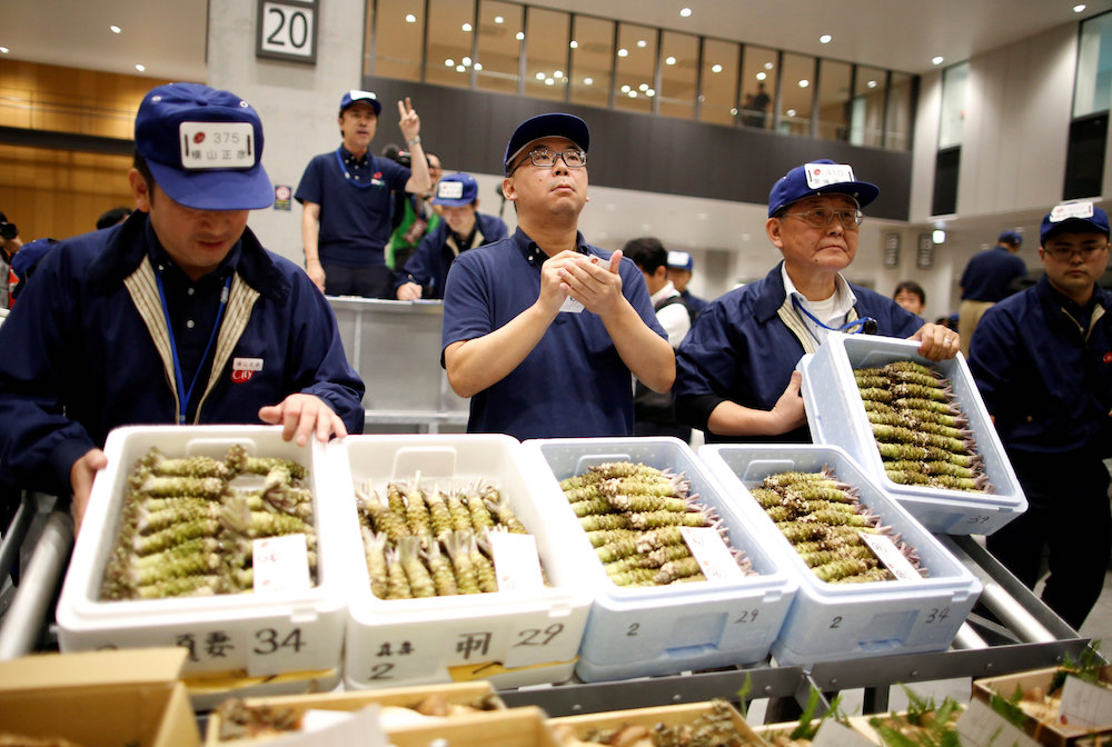 Auctioneers take part in a wasabi auction at the greengrocery area on the opening day of the new Toyosu market, which has been relocated from Tsukiji market, in Tokyo October 11, 2018. — Reuters pic