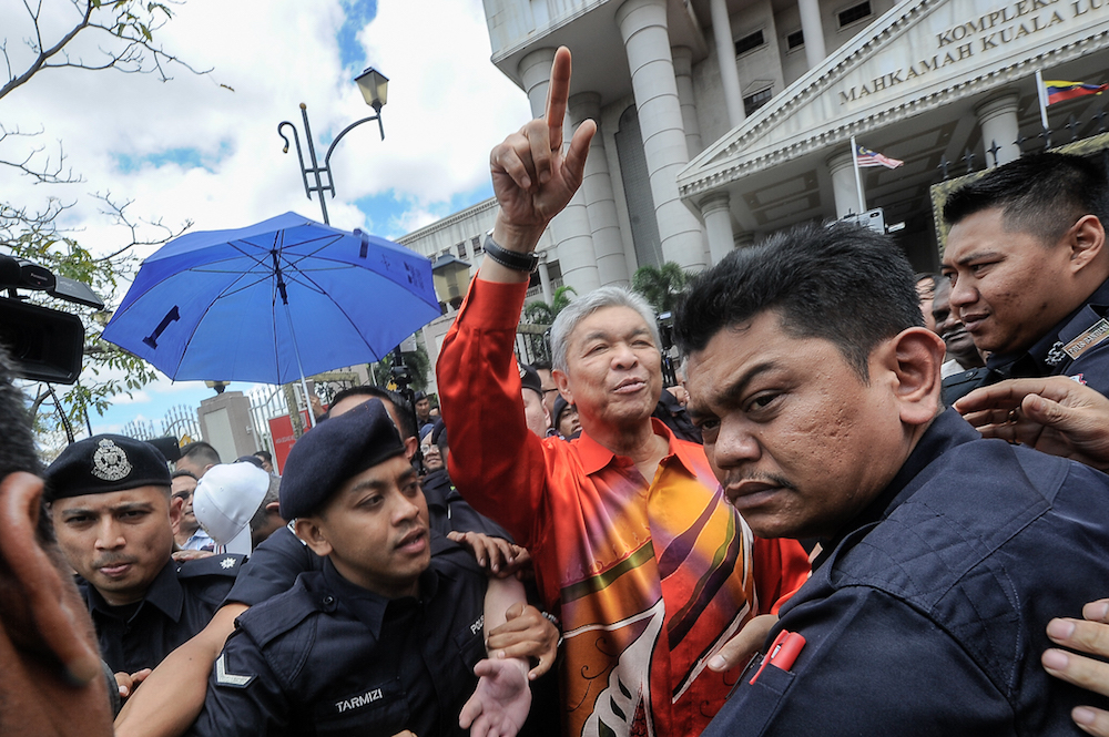 Umno president Datuk Seri Ahmad Zahid Hamidi gestures as he leaves the Kuala Lumpur High Court Complex October 19, 2018. u00e2u20acu201d Picture by Shafwan Zaidon