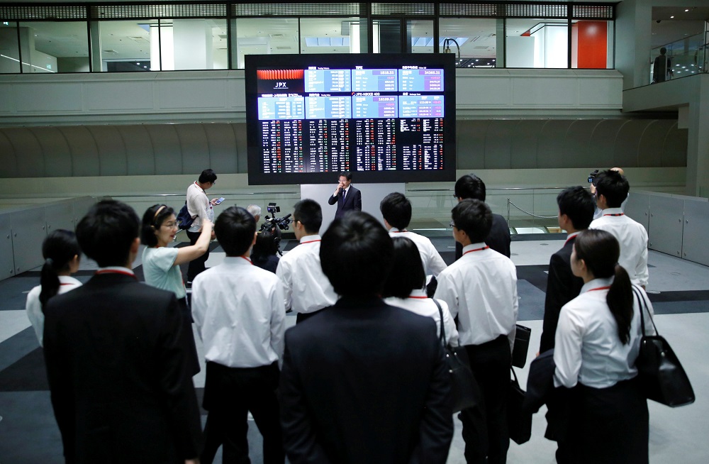Visitors look at an electronic stock quotation board at the Tokyo Stock Exchange in Tokyo October 1, 2018. u00e2u20acu201d Reuters pic