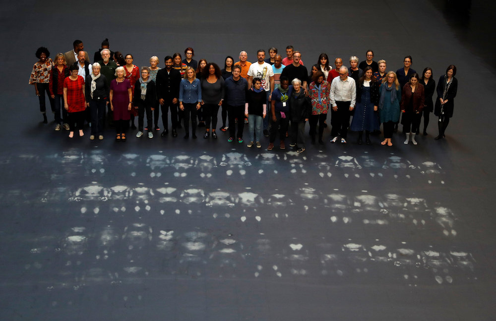 Volunteers stand after lying down on the heat-sensitive Hyundai Commission artwork, u00e2u20acu02dcOur Neighboursu00e2u20acu2122, in the Turbine Hall of Tate Modern, London October 1, 2018. u00e2u20acu201d Reuters pic