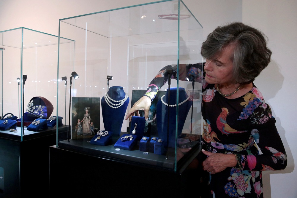 A member of Sothebyu00e2u20acu2122s staff reaches for a pearl and diamond pendant once belonging to Queen Marie Antoinette of France on display at Sothebyu00e2u20acu2122s in Dubai October 9, 2018. u00e2u20acu201d Reuters pic