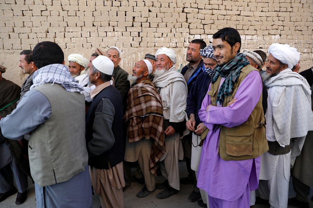 Afghan men wait to cast their votes during a parliamentary elections in Kabul October 20, 2018. u00e2u20acu201d Reuters pic