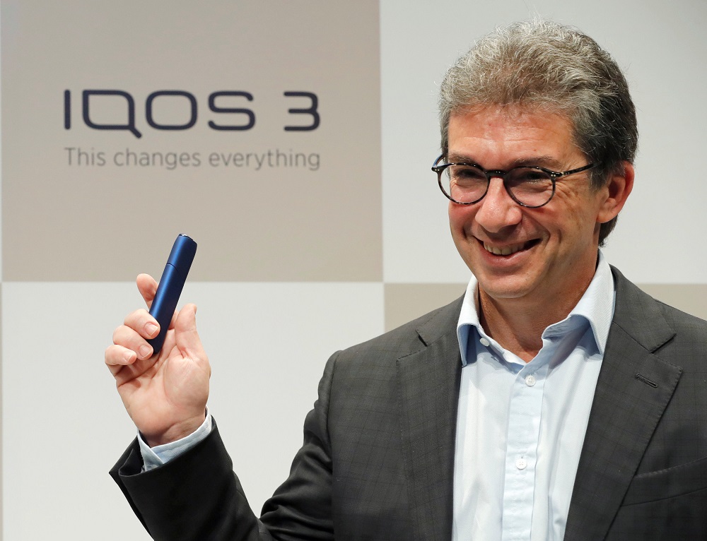 Philip Morris Internationalu00e2u20acu2122s CEO Andre Calantzopoulos poses with the new IQOS 3 devices at a news conference in Tokyo October 23, 2018. u00e2u20acu201d Reuters pic
