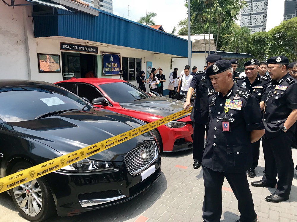Bukit Aman NCID director Datuk Seri Mohmad Salleh inspecting the seized vehicles, including the Jaguar XF luxury saloon at the Johor police contingent headquarters in Johor Baru October 16, 2018. 