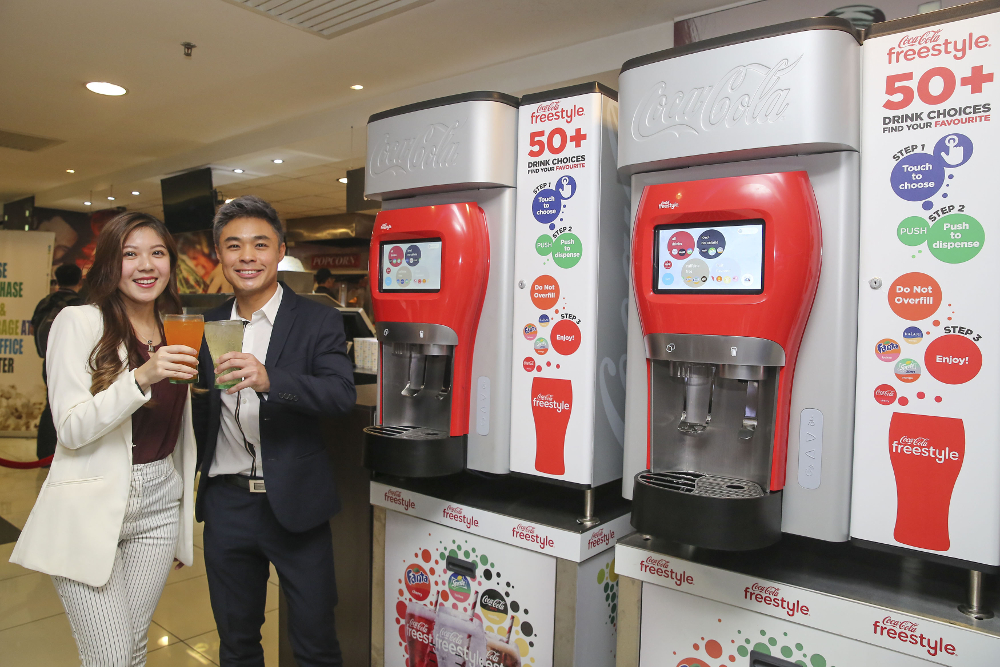 mmCineplexes Director of Marketing and Business Development Jason Teo and Coca-Cola Malaysia Growth and Innovation Executive Lee Sook Yan introducing Malaysians to Coca-Cola Freestyle. u00e2u20acu201d Picture by Yusof Mat Isa