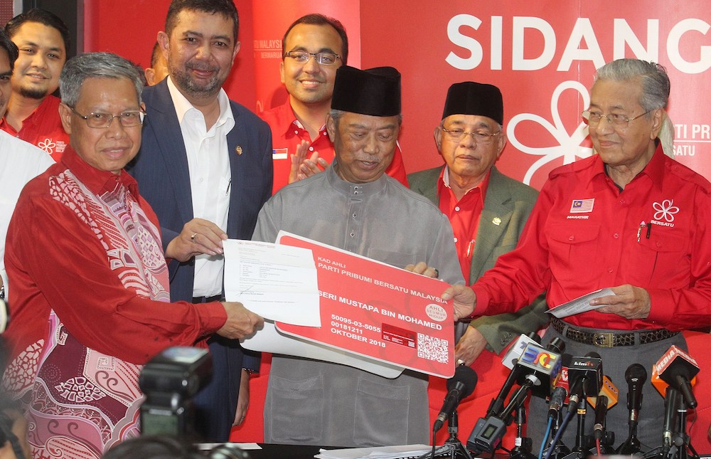 Datuk Seri Mustapa Mohamed receives a mock membership card from PPBM chairman Tun Dr Mahathir Mohamad at a special ceremony in Petaling Jaya October 26, 2018. — Picture by Razak Ghazali
