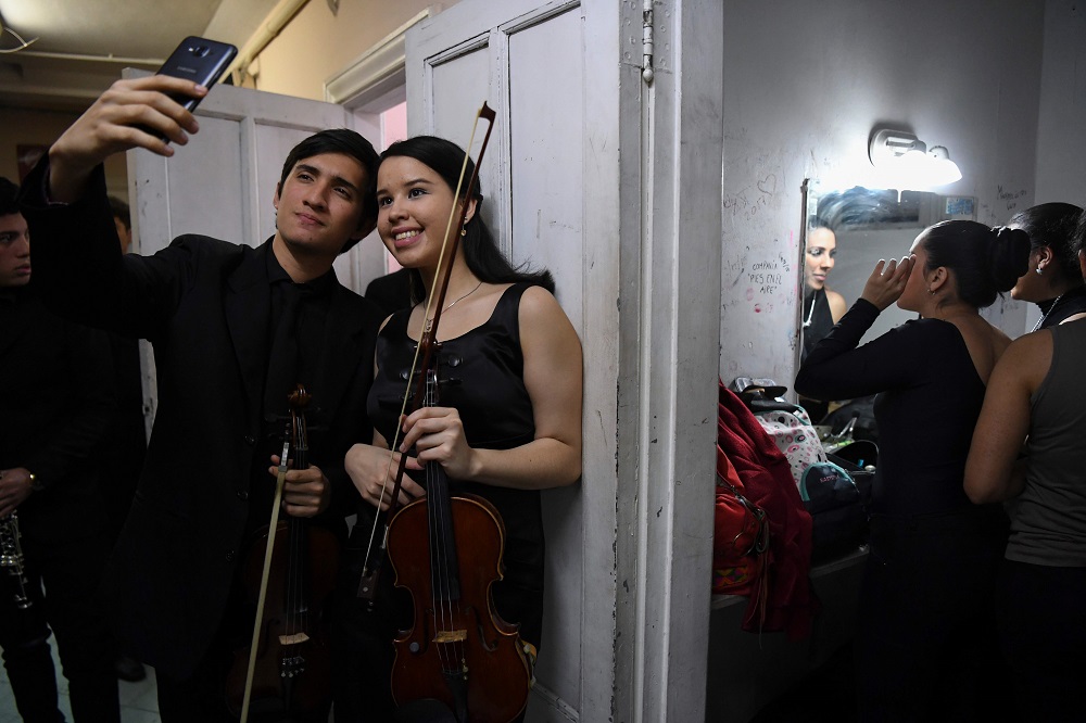 Latin Vox Machine orchestra members pose for a selfie backstage before performing at a theatre in Buenos Aires October 09, 2018. u00e2u20acu201d AFP pic  