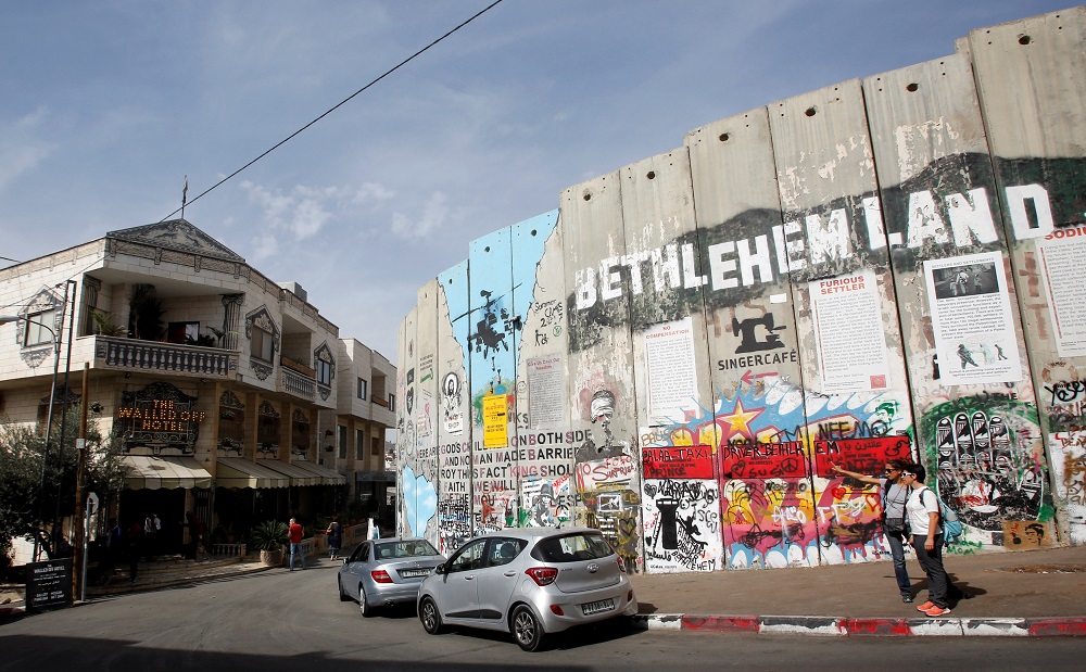A view shows Banksy’s the Walled Off hotel and a section of the Israeli barrier in Bethlehem, in the occupied West Bank October 23, 2018. — Reuters pic