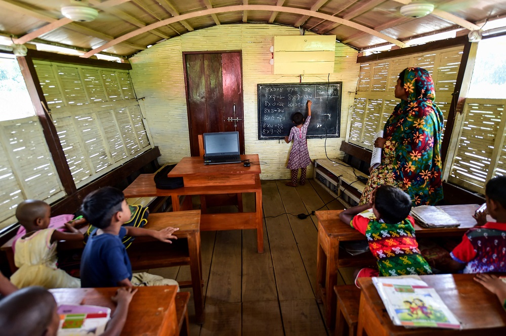 In this photograph taken on September 4, 2018, Bangladeshi students attend a u00e2u20acu02dcfloating schoolu00e2u20acu2122, operated by the Shidhulai Swanirvar Sangstha charity, in Chalan Beel in Rajshahi district. u00e2u20acu201d AFP pic 