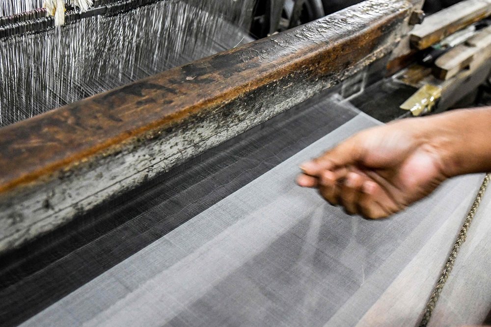 This photograph taken on September 5, 2018, shows a Bangladeshi worker making silk products in a silk factory in Rajshahi. — AFP pic