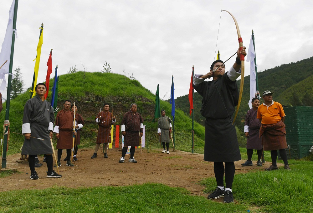 In this photo taken on August 25, 2018, Bhutanese archers watch another take aim at the target at the Changlimithang Archery Ground in Thimphu. u00e2u20acu201d AFP pic