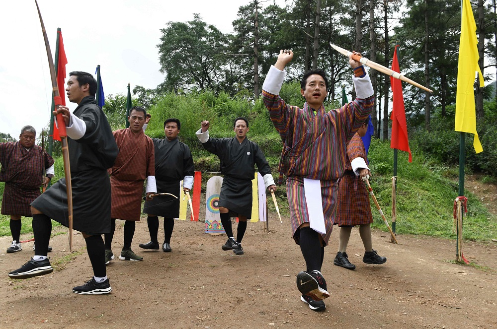 In this photo taken on August 25, 2018, Bhutanese archers performs a leg-kicking dance after hitting a target at the Changlimithang Archery Ground in Thimphu. — AFP pic 