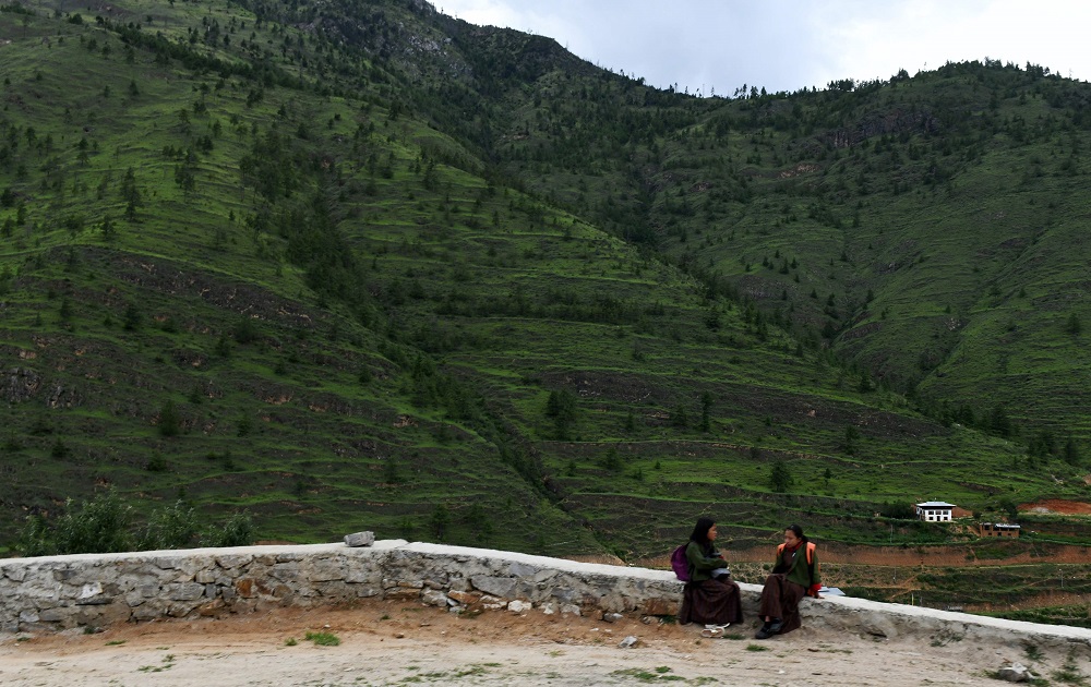 A Bhutanese girls wait for a shuttle at a bus stop in the town of Kahasadrapchu in the outskirts of Thimbhu August 22, 2018. u00e2u20acu201d AFP pic 