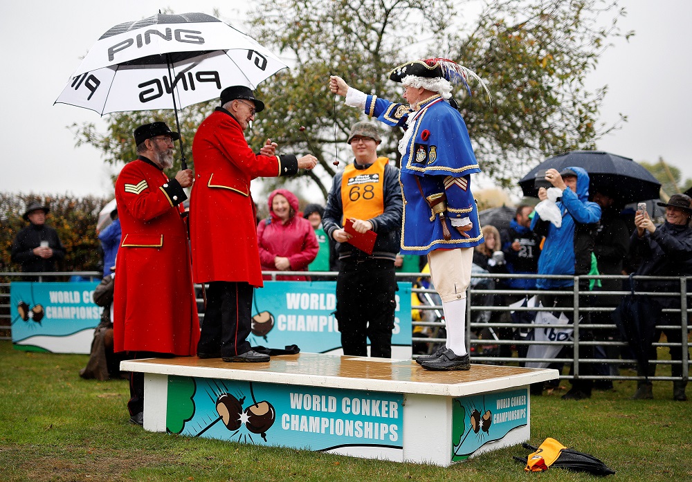 Chelsea Pensioner, and 2017 champion, John Riley (left) plays his first round match during the World Conker Championships in Southwick October 14, 2018. — Reuters pic