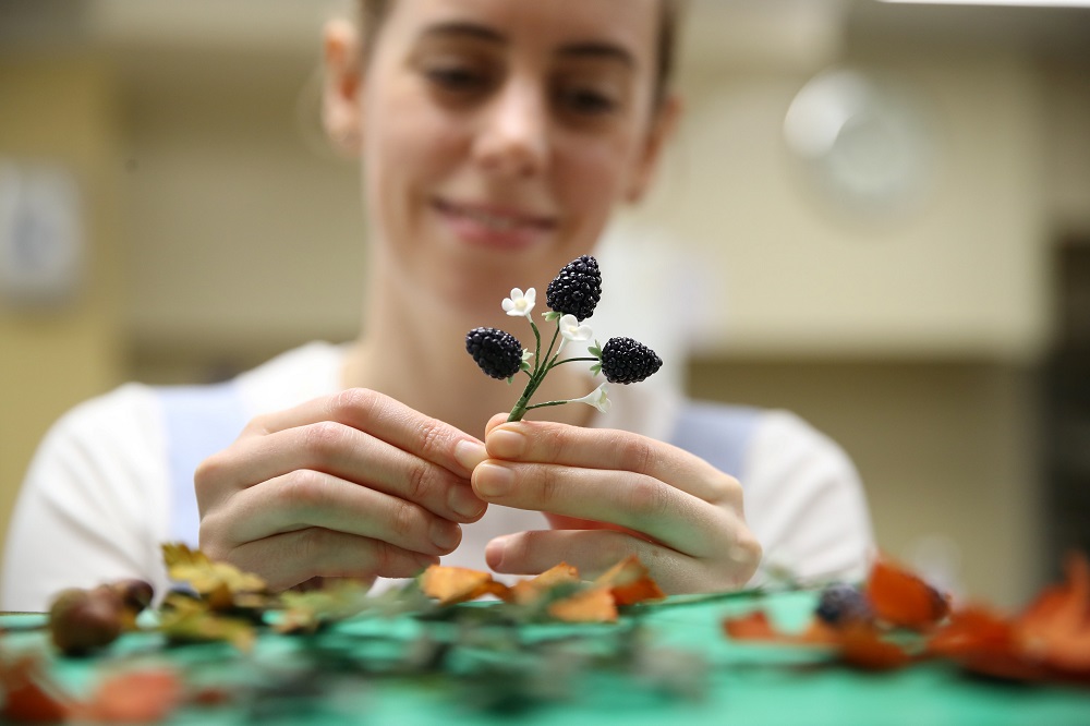 Baker Sophie Cabot puts the finishing touches to the cake decorations for the wedding cake for the marriage of Britainu00e2u20acu2122s Princess Eugenie and Jack Brooksbank, at Buckingham Palace in London October 10, 2018. u00e2u20acu201d Reuters pic
