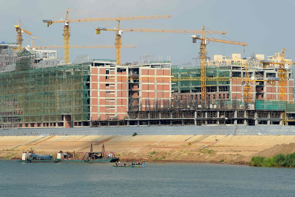 Boats are pictured along the river near new buildings under construction in Phnom Penh April 25, 2018. u00e2u20acu201d AFP pic 