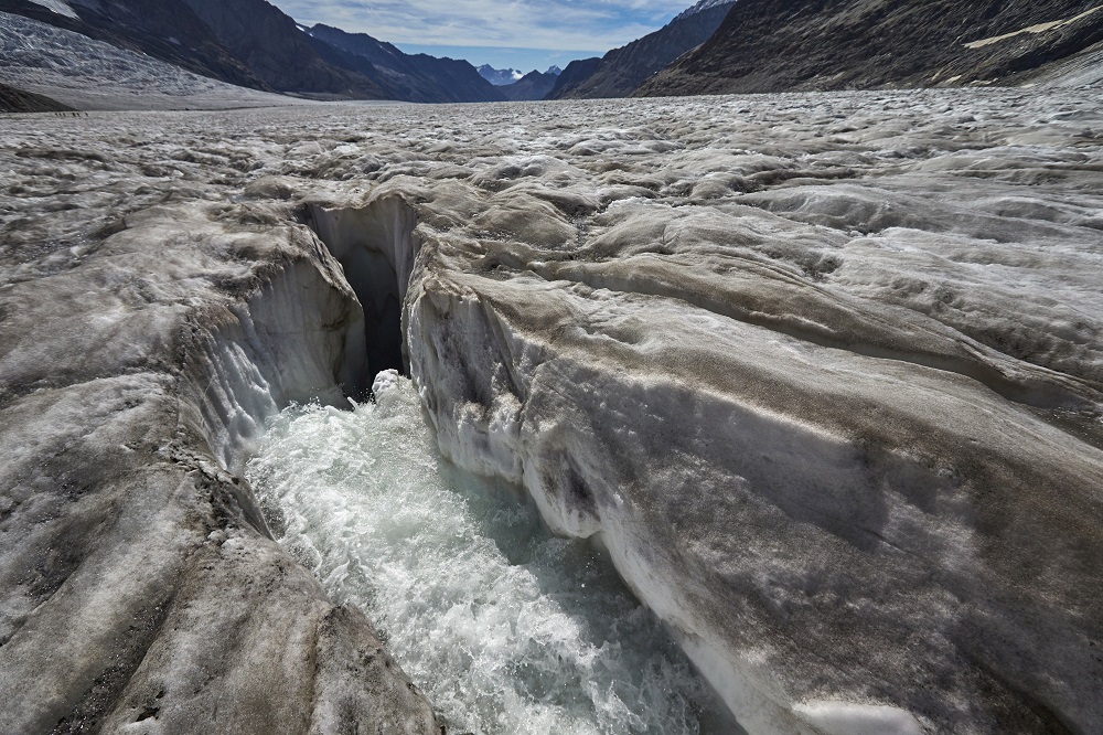 Water from the melting glacier runs down through a hole in the Aletsch Glacier on the Jungfraufirn Glacier, Switzerland August 28, 2015. u00e2u20acu201d Reuters pic  