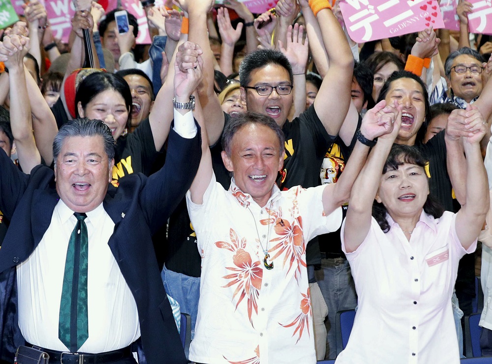 Danny Tamaki raises his hands with supporters in celebration after he was elected in gubernatorial election in Naha, on the Japanese southern island of Okinawa, in this photo taken by Kyodo September 30, 2018. u00e2u20acu201d Reuters pic