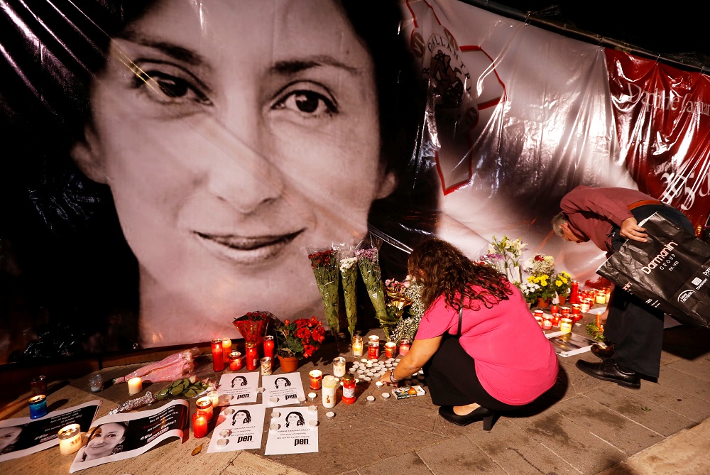 People lay flowers and candles at a makeshift memorial during a vigil and protest on the first anniversary of the assassination of Daphne Caruana Galizia in a car bomb, outside the Courts of Justice in Valletta, Malta October 16, 2018. u00e2u20acu201d Reuters pic