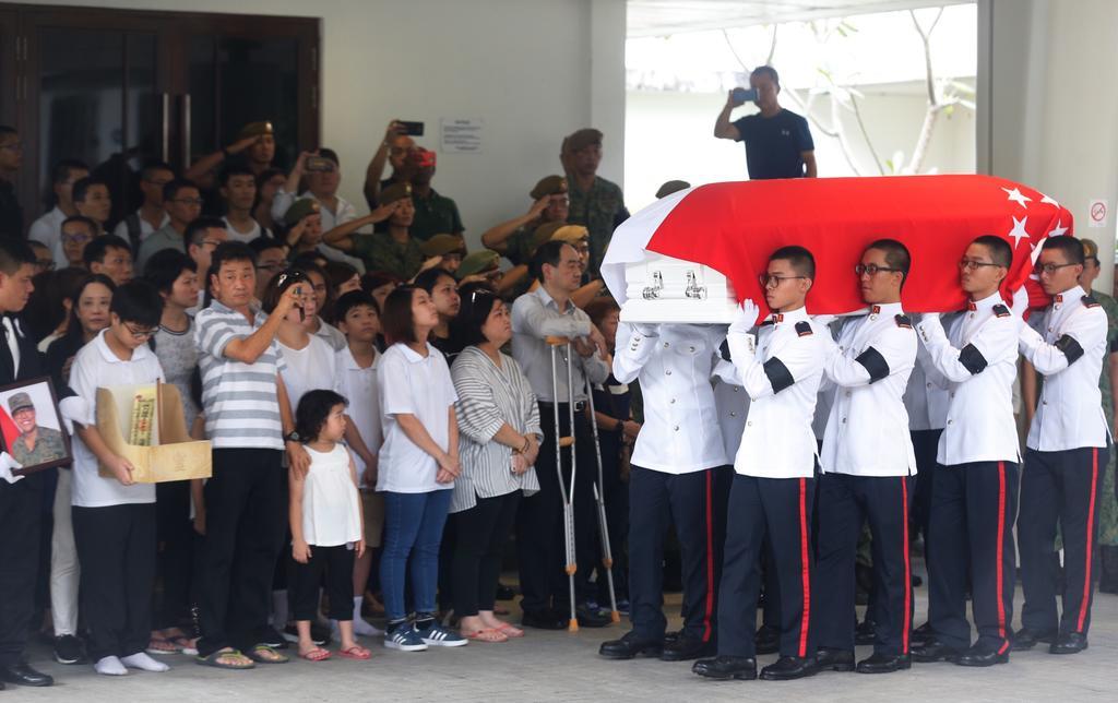 Soldiers carrying the coffin of full-time national serviceman Dave Lee Han Xuan into the hall at Mandai Crematorium during his military funeral. u00e2u20acu201d Najeer Yusof/TODAY picn