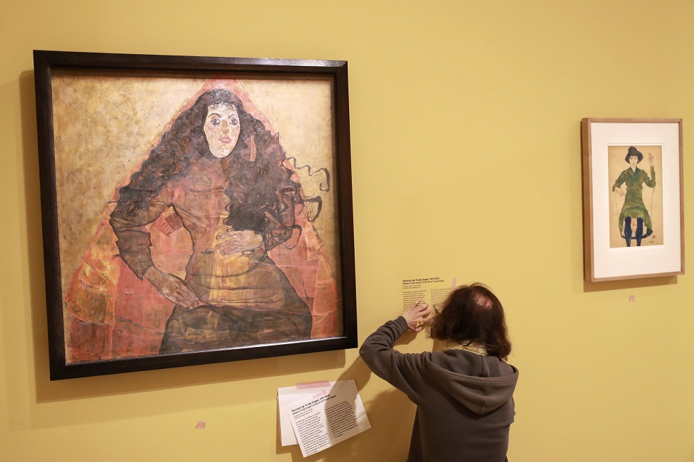 A staff member installs the label by an artwork by Austrian artist Egon Schiele entitled u00e2u20acu02dcBildnis Trude Engelu00e2u20acu2122 (Portrait de Trude Engel) during a press visit at the Fondation Louis Vuitton in Paris September 26, 2018. u00e2u20acu201d AFP pic    