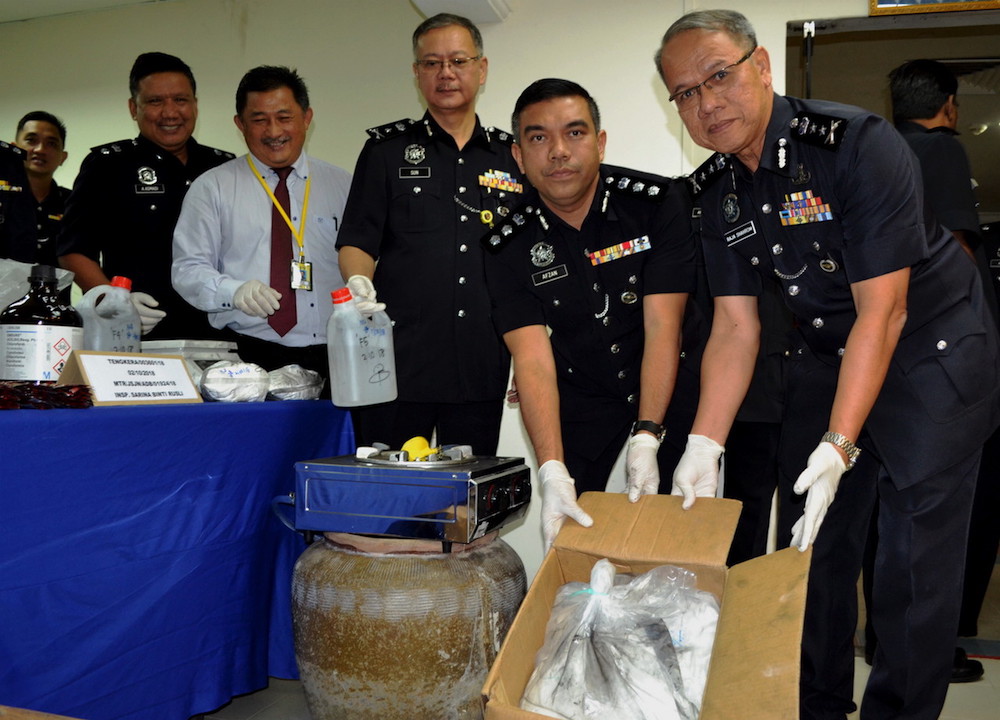 Melaka police chief Datuk Raja Shahrom Raja Abdullah poses for pictures with the seized drugs during a press conference in Melaka October 3, 2018. u00e2u20acu201d Bernama pic
