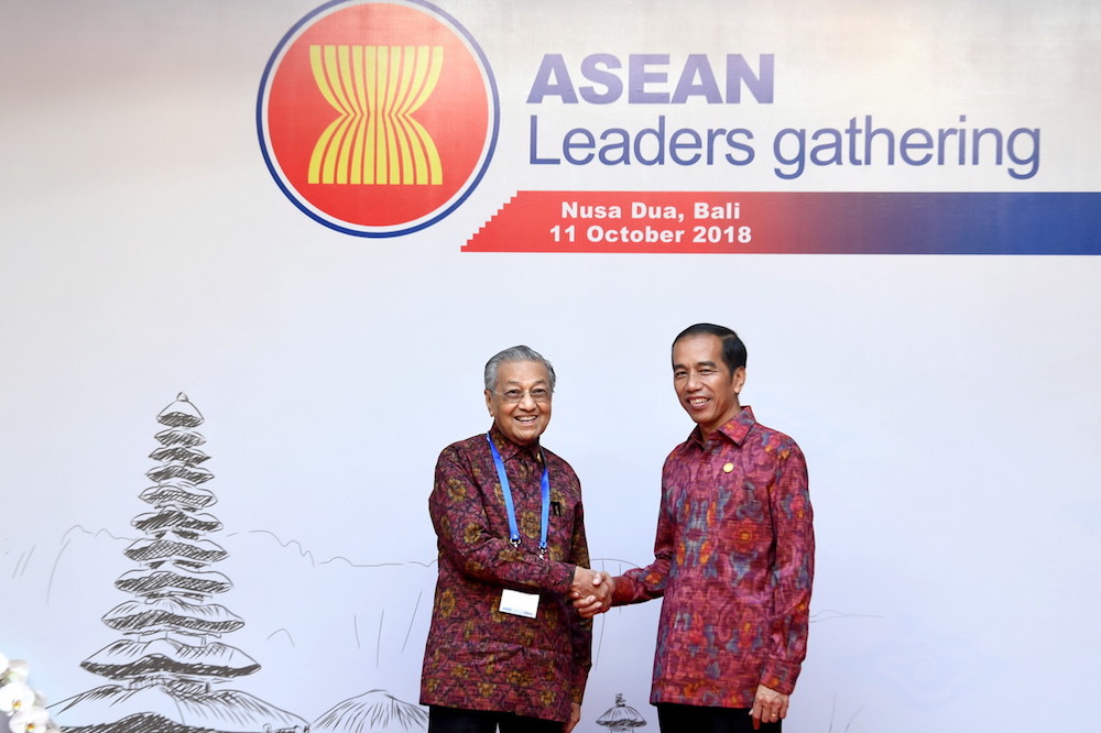Tun Dr Mahathir Mohamad shakes hands with Indonesiau00e2u20acu2122s President Joko Widodo at the Asean Leaders Gathering in Bali October 11, 2018. u00e2u20acu201d Bernama pic