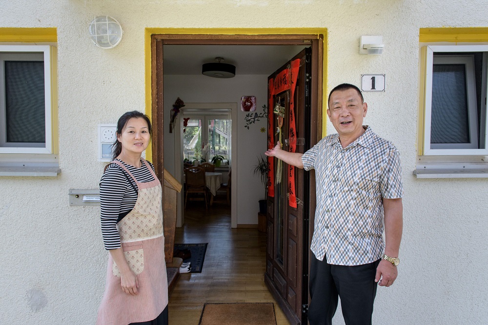 Zhang and his wife Yang from China, pose in front of their house at the so-called u00e2u20acu02dcOak Gardenu00e2u20acu2122 residential complex in the German western town of Hoppstaedten-Weiersbach, where 1000 Chinese people live September 8, 2018.  u00e2u20acu201d AFP pic