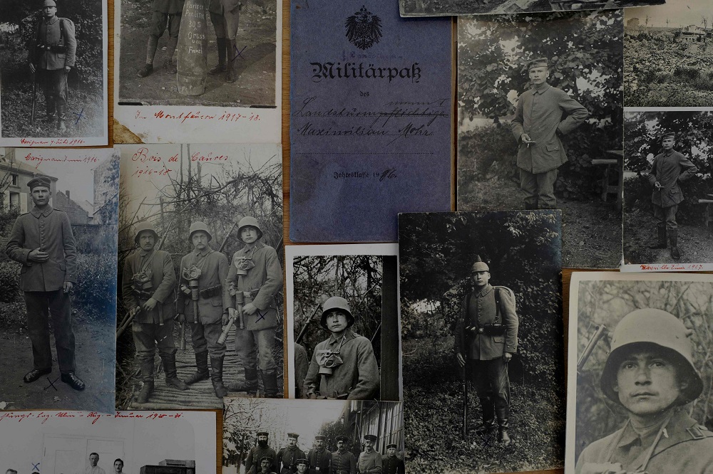 Various World War I photos showing Joachim Mohr's grandfather Maximilian Mohr, including his military pass are displayed at Joachim's home in Hamburg October 10, 2018. u00e2u20acu201d AFP pic  