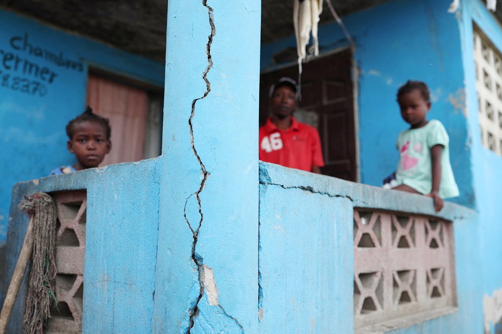A man and two children stand on the porch of their home after it was damaged in an earthquake, that hit northern Haiti late on Saturday, in Port-de-Paix, Haiti, October 8, 2018. u00e2u20acu201d Reuters pic