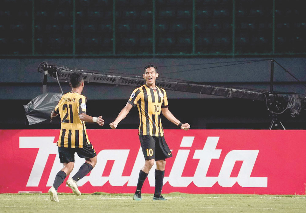 Hadi (right) celebrates giving Malaysia the lead. u00e2u20acu201d Picture by AFC