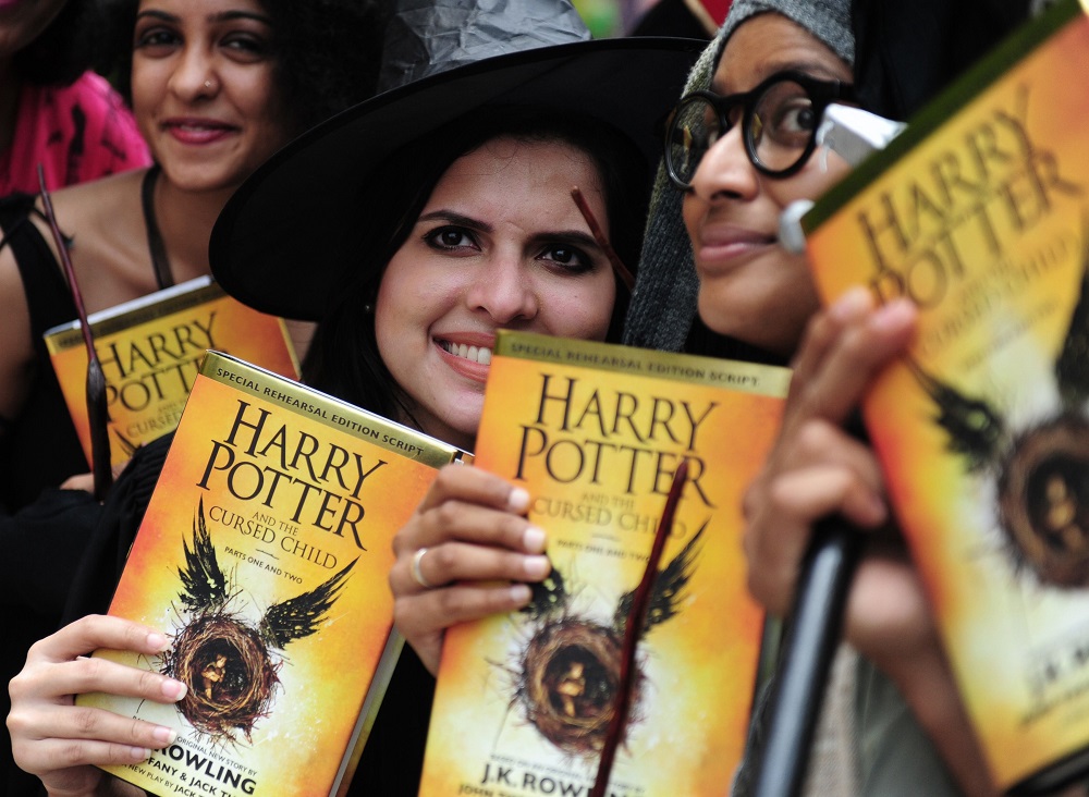 In this file photo taken on July 31, 2016, Indian people pose for photographers with copies of J.K. Rowlingu00e2u20acu2122s new book u00e2u20acu02dcHarry Potter and the Cursed Childu00e2u20acu2122 during an event to mark the book launch at a mall in Chennai. u00e2u20acu201d AFP pic  