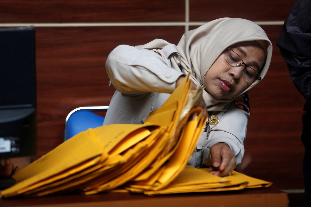 An Indonesian Disaster Victim Identification (DVI) officer searches for identity documents of passengers on the crashed Lion Air flight JT610, at Bhayangkara R. Said Sukanto hospital in Jakarta, Indonesia, October 30, 2018. u00e2u20acu201d Reuters pic