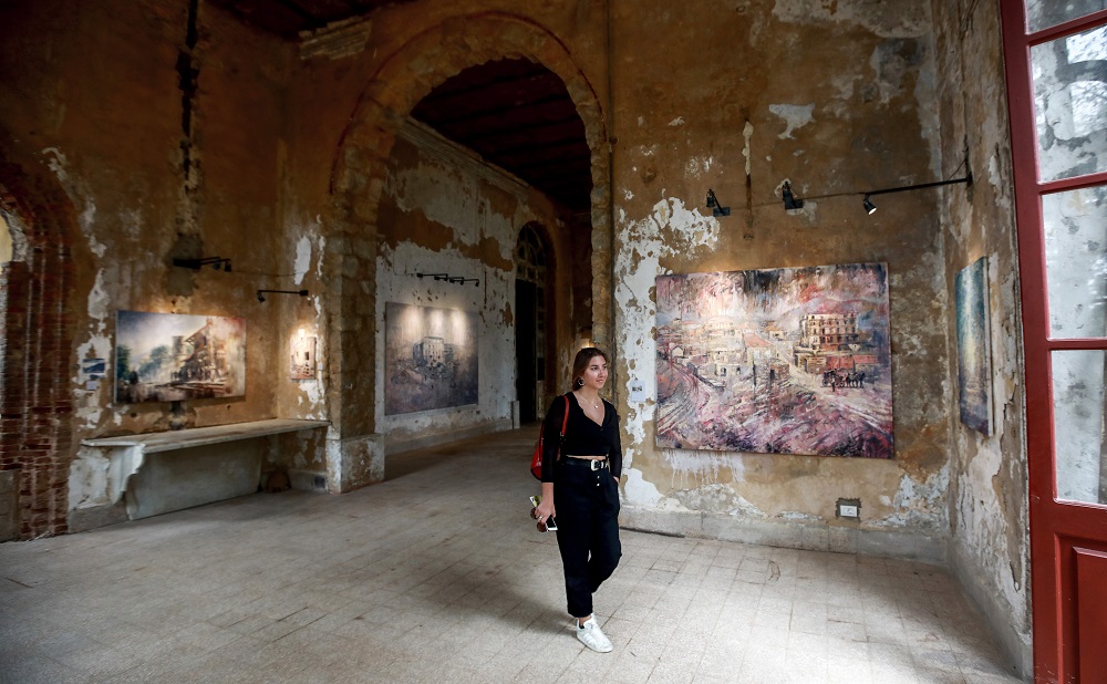 This picture taken on September 21, 2018, shows a visitor walking through a hallway at the Sofar Grand Hotel in the Lebanese village of Sofar, some 30 kilometres east of Beirut, during an exhibition by 45-year-old British painter Tom Young. u00e2u20acu201d AFP pic   