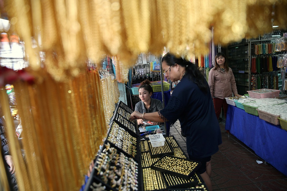 A woman sells fake gold on a street in Chinatown in Bangkok February 8, 2018. u00e2u20acu201d Reuters pic  