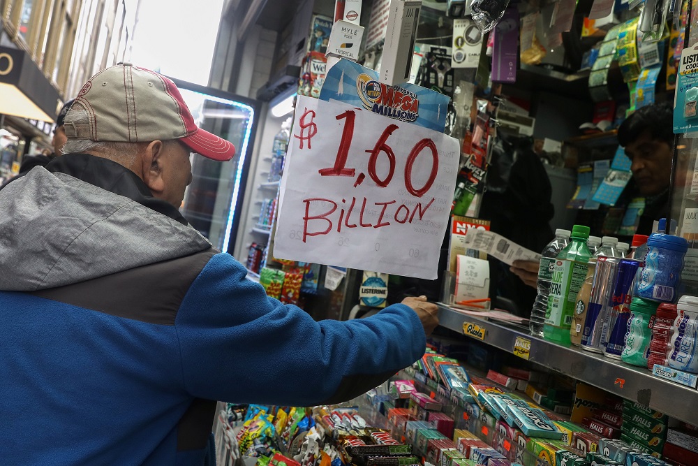 A man buys tickets for Tuesday's Mega Millions lottery drawing after the jackpot exceeded US$1.6 billion in New York City, New York, October 23, 2018. u00e2u20acu201d Reuters pic