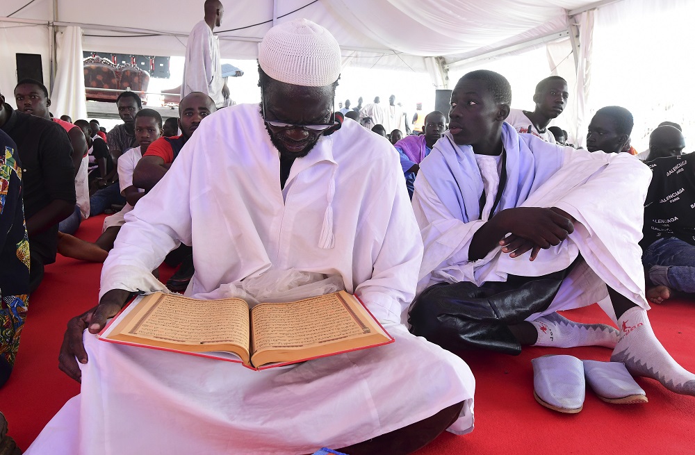Pilgrims of the Mouride Brotherhood, a Sufi order, read khassayites, written by their spiritual guide Serigne Touba, under a tent near the Great Mosque of Touba, on October 27, 2018. u00e2u20acu201d AFP pic