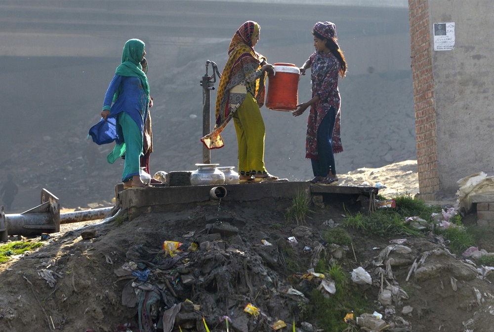 In this picture taken on February 25, 2018, Pakistani residents fill their cans with drinking water from a filtration plant donated by the Junaid Jamshed foundation in Kot Assadullah, around 45km from Lahore. — AFP pic
